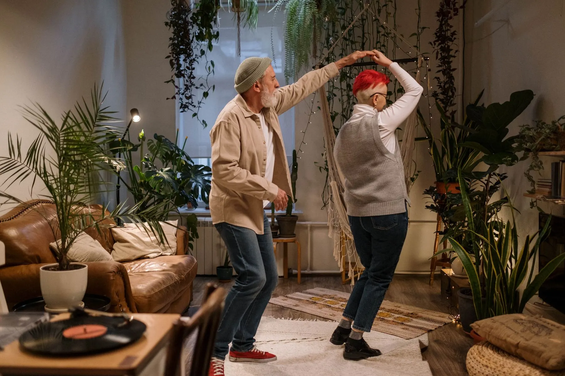 A couple spins through a dance in their living room.